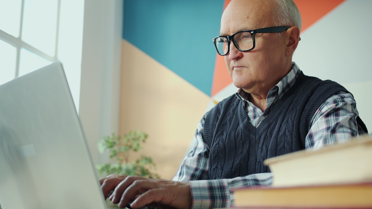 Older adult building confidence by learning technology on a laptop