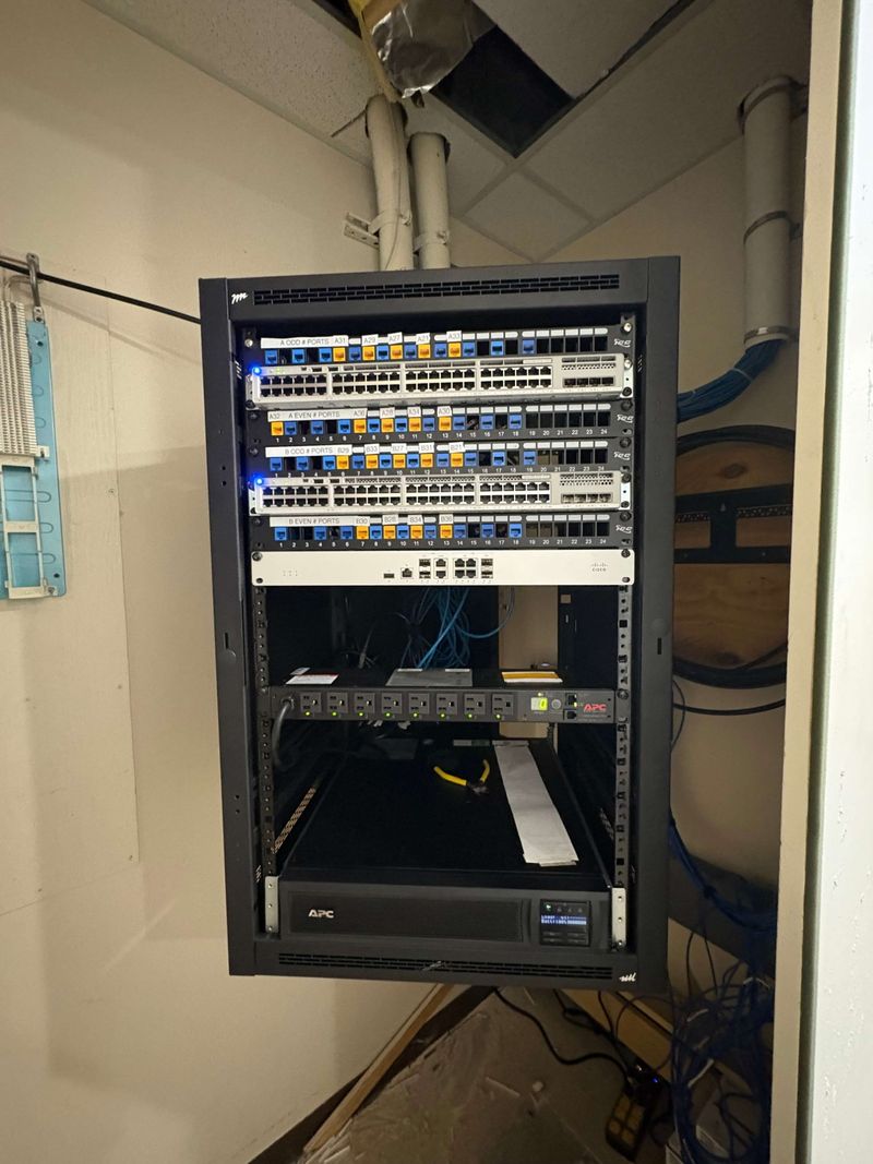 Completed business network rack in Fort Worth with labeled patch panels, network switches, firewall, rack PDU and UPS
