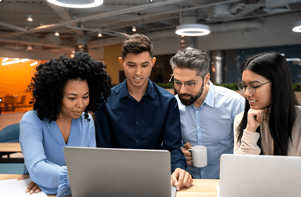 Team working together on business project with computers